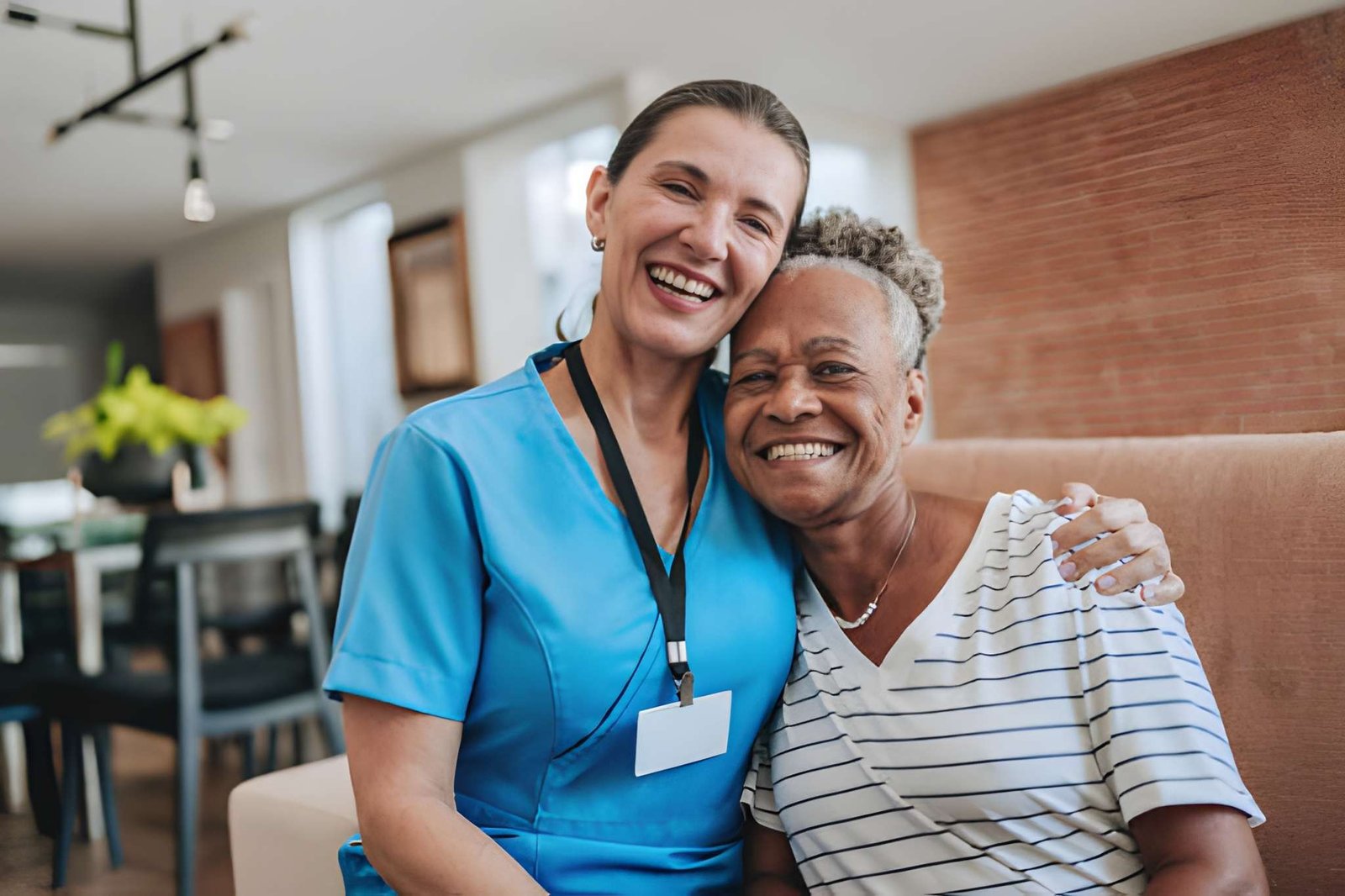 Caregiver and older adult smiling together