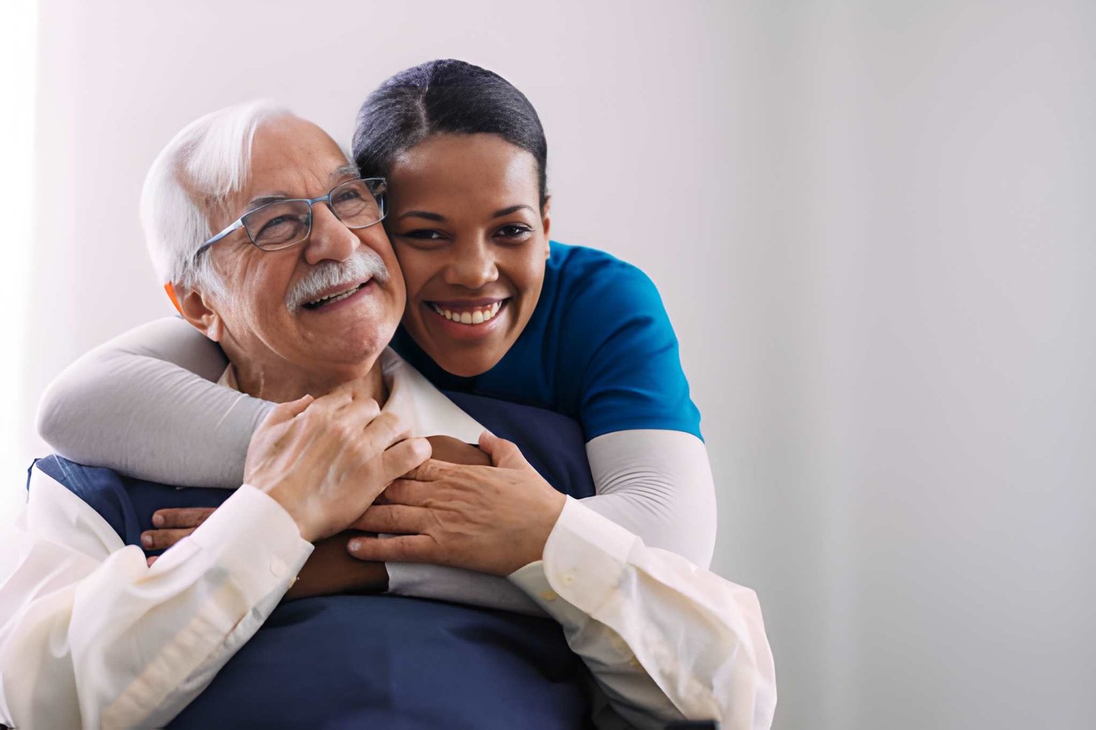 Caregiver embracing a smiling older adult