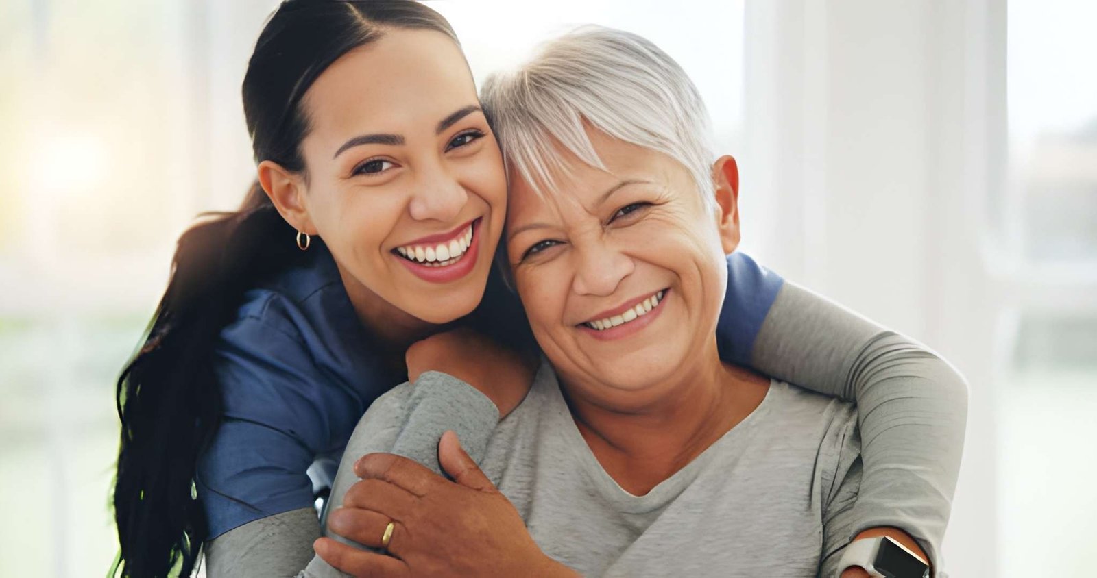 Older adult and caregiver sharing a reassuring embrace
